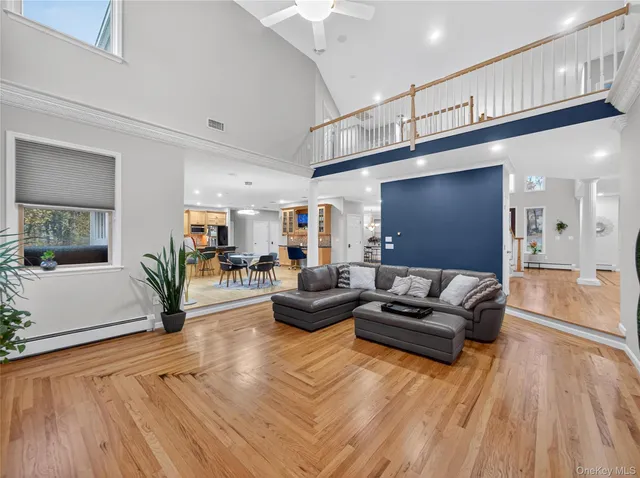 a living room with furniture and a wooden floor