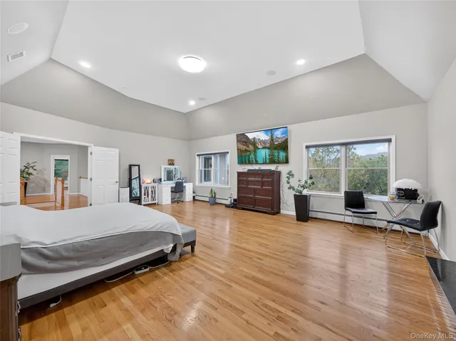 a bedroom with furniture and a wooden floor