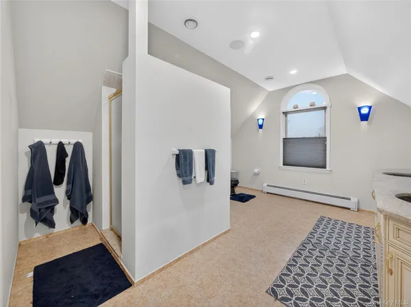 a hallway with front door and bedroom view