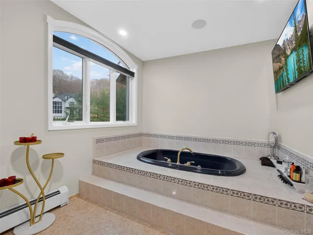 a bathroom with a tub and a sink