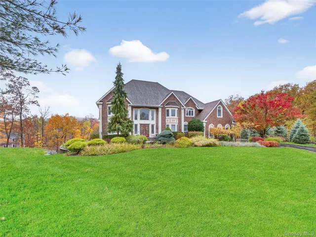 a front view of a house with a garden and plants
