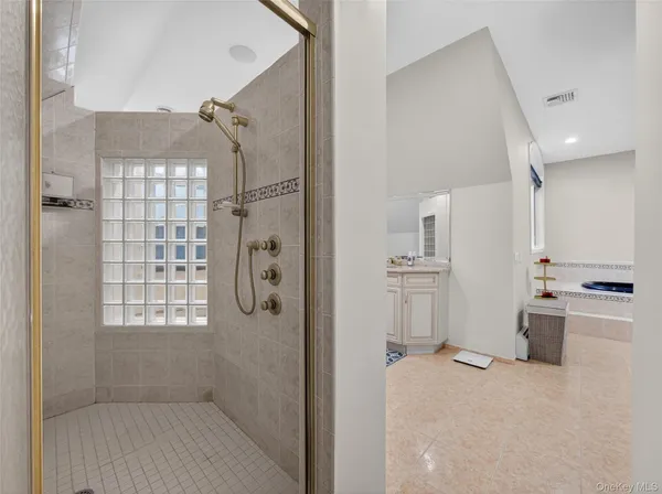 a bathroom with a bathtub and a shower