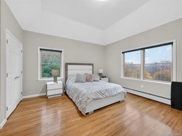 a bedroom with a large bed and a large window