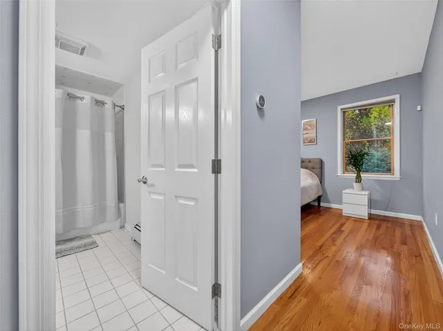 a view of a bedroom with tub and window