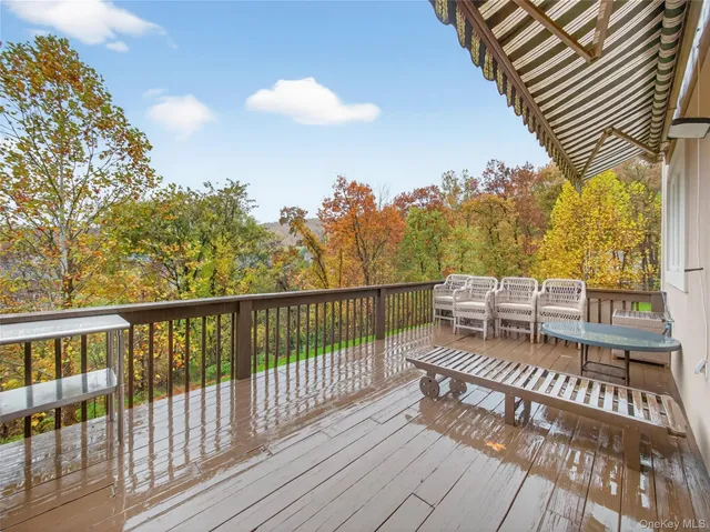a view of a balcony with wooden floor and fence