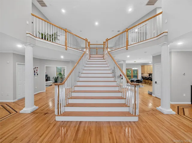 a view of entryway and hall with wooden floor
