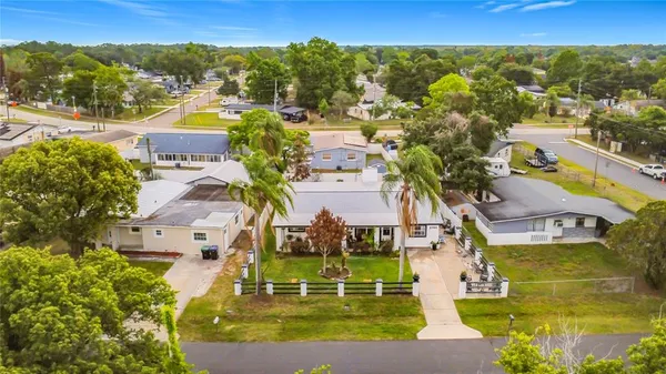 an aerial view of residential houses with outdoor space and swimming pool