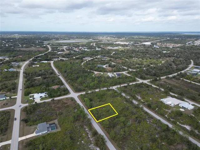 an aerial view of a house with a yard and lake view