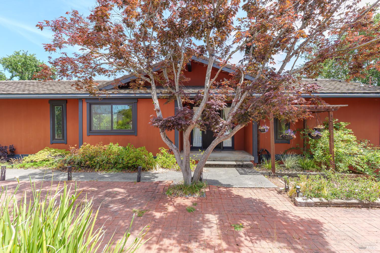 a front view of a house with garden