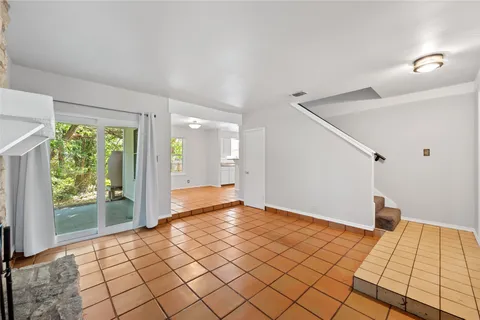 a view of a kitchen with wooden floor and a window