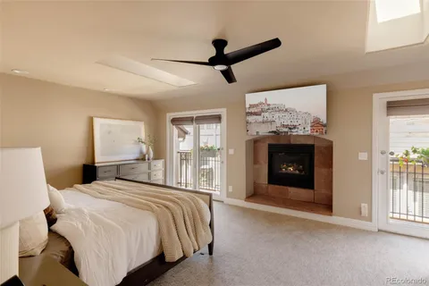 a bathroom with a granite countertop double vanity sink a mirror and a bathtub