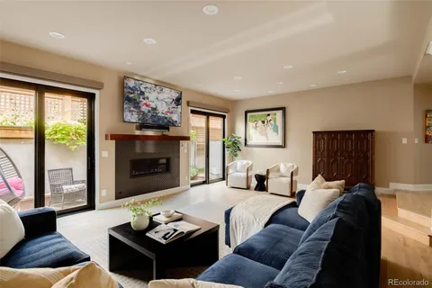 a living room with furniture fireplace and a large window