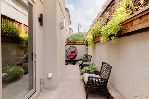 a balcony with table and chairs