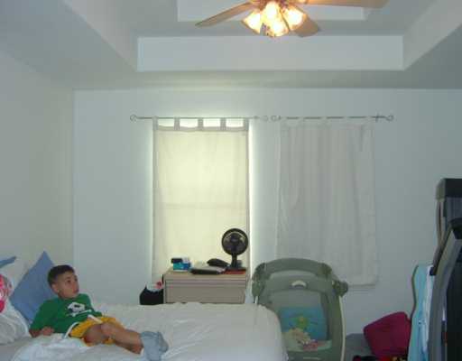 15633 Dyna Street Corpus Christi, TX 78418 - Photo 6 of 8 a bedroom with a bed and a window