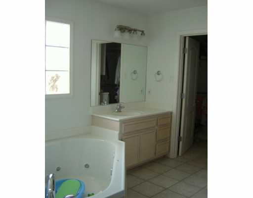 15633 Dyna Street Corpus Christi, TX 78418 - Photo 7 of 8 a bathroom with a sink and a mirror