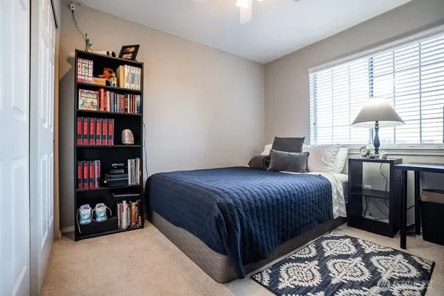 a bedroom with a bed a dresser and a book shelf
