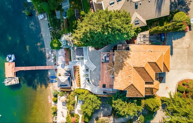 an aerial view of residential houses with outdoor space and swimming pool