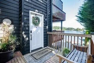 a view of a house with a small yard and wooden floor