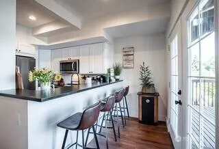 a dining room with furniture and potted plants