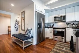 a kitchen with white cabinets and stainless steel appliances