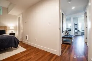 a view of a bedroom with wooden floor