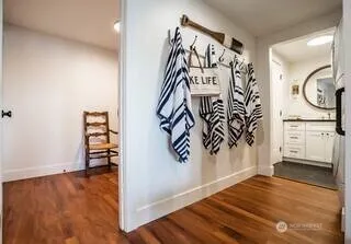 wooden floor with white walls and stairs