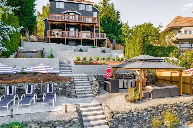 an outdoor space with seating area and barbeque oven