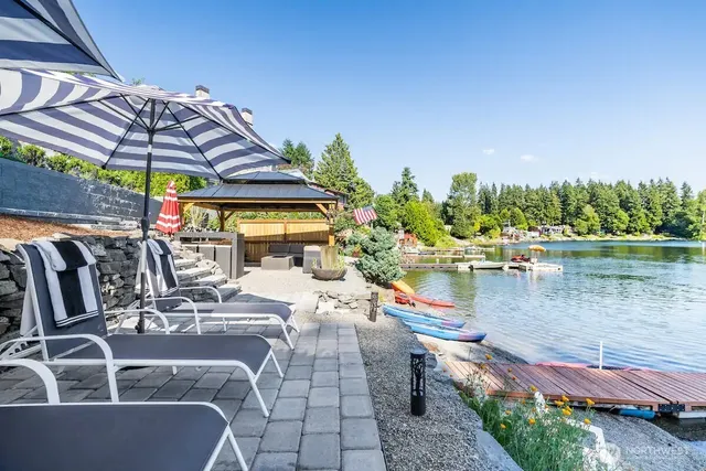 a view of swimming pool with outdoor seating and plants