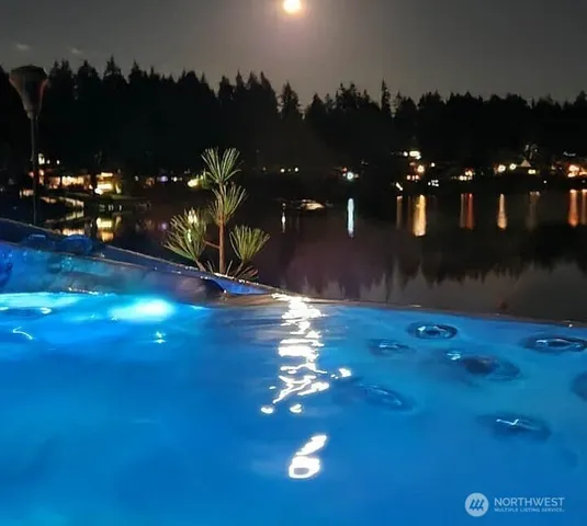 a view of a swimming pool with an outdoor space and seating area