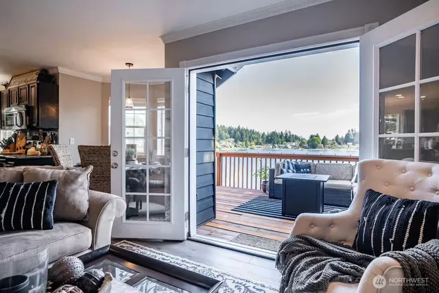 a balcony with furniture and a floor to ceiling window