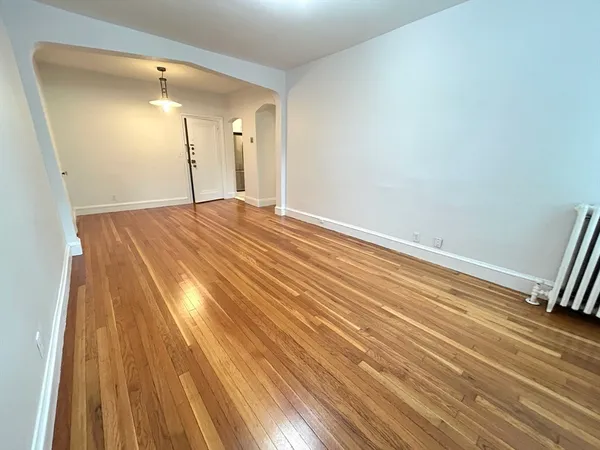 a view of an empty room and wooden floor