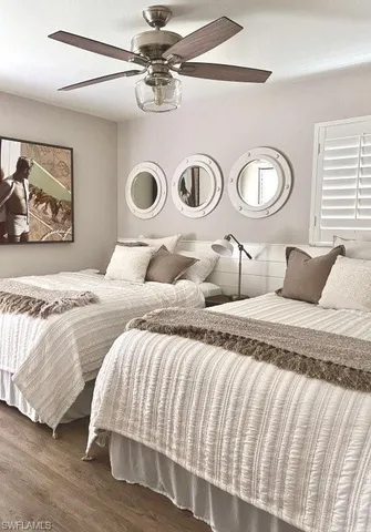 a bedroom with a bed and painting on the wall