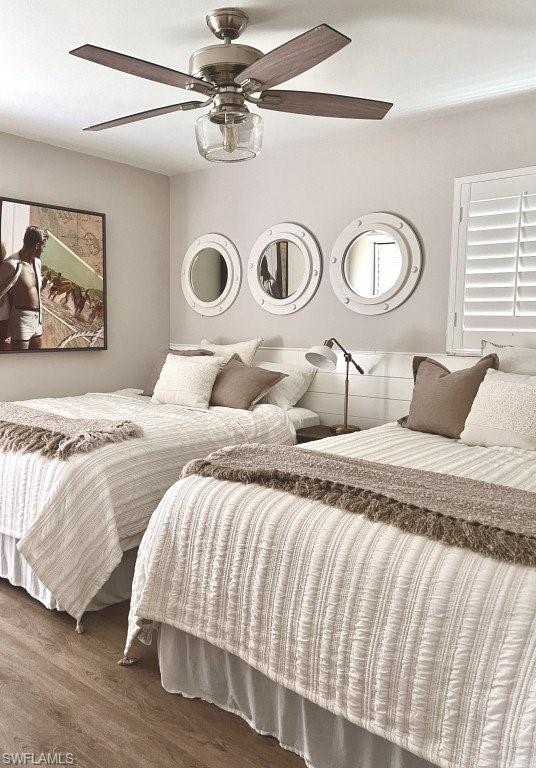 12 Knights Bridge Road, Unit A32 Naples, FL 34112 - Photo 11 of 17 a bedroom with a bed and painting on the wall