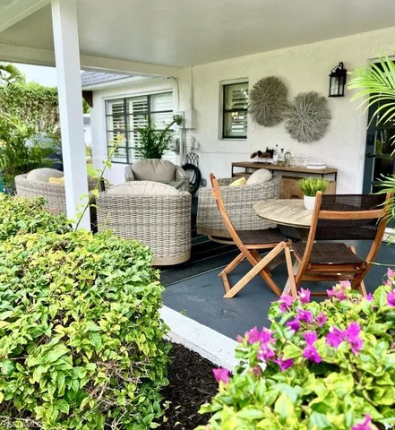 a living room with furniture and flowers