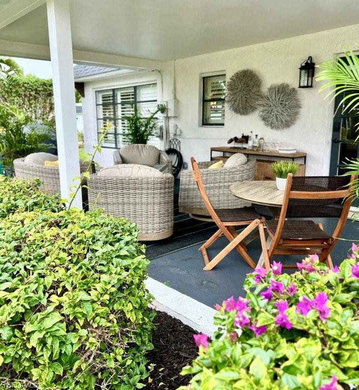 12 Knights Bridge Road, Unit A32 Naples, FL 34112 - Photo 14 of 17 a living room with furniture and flowers