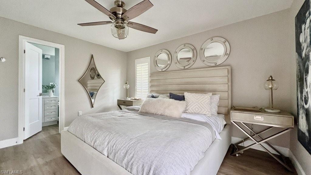 12 Knights Bridge Road, Unit A32 Naples, FL 34112 - Photo 7 of 17 a bedroom with a bed and a chandelier