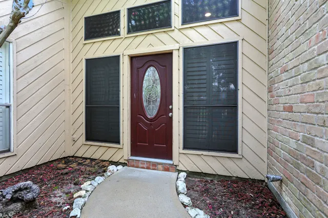 a kitchen with a sink cabinets stainless steel appliances and a window