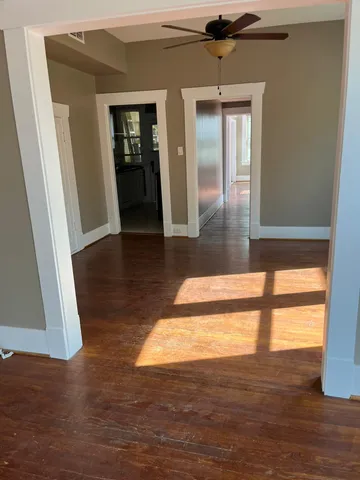 a view of hallway with wooden floor