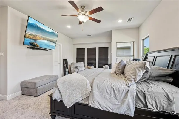 a bedroom with a bed and a flat screen tv