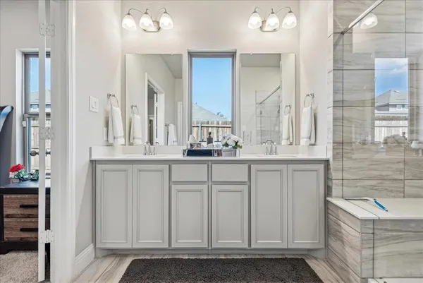 a bathroom with a sink vanity and a mirror