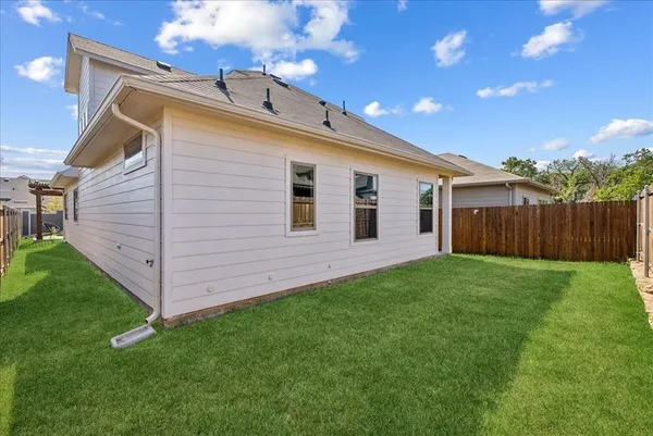 a view of a backyard with plants and a garden