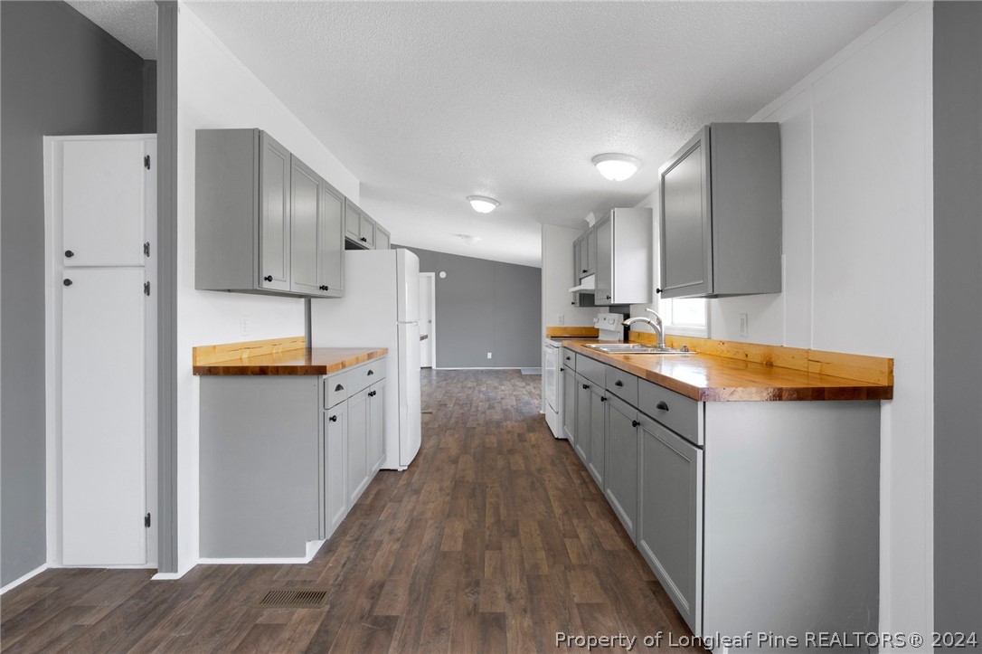 152 Three Bridges Road Rowland, NC 28383 - Photo 11 of 27 a kitchen with a sink a counter top space stainless steel appliances and cabinets