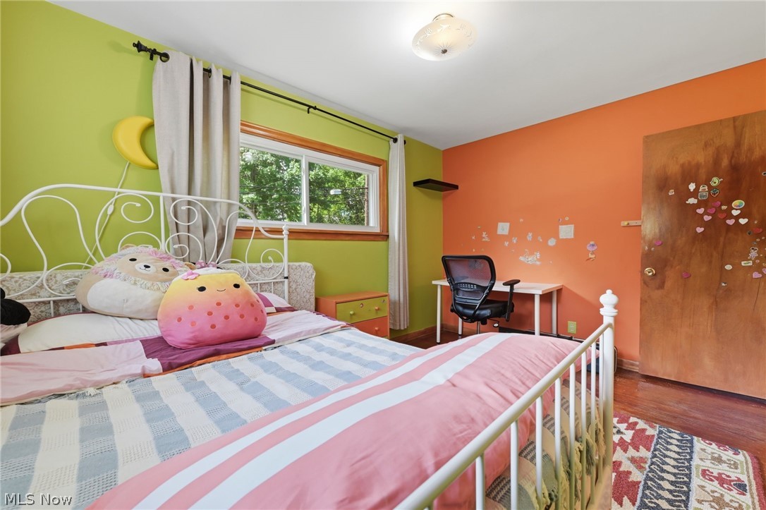 1499 Morris Road Kent, OH 44240 - Photo 13 of 41 Bedroom featuring vibrant two-tone wall colors, wood-finish flooring, and a large window providing ample natural light