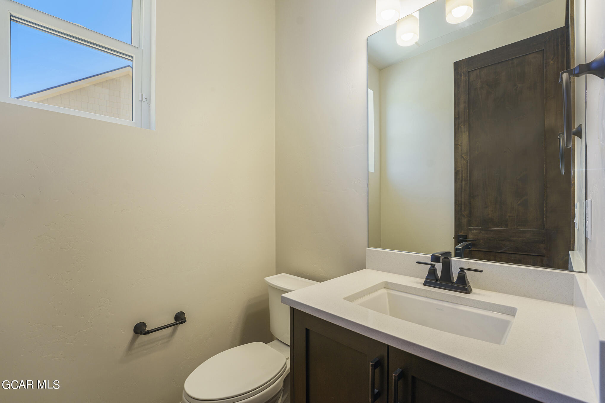 127 Homestead Loop Fraser, CO 80442 - Photo 13 of 22 a bathroom with a granite countertop sink toilet and a mirror
