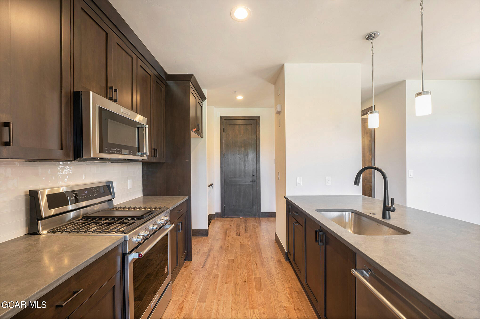 127 Homestead Loop Fraser, CO 80442 - Photo 9 of 22 a kitchen with stainless steel appliances granite countertop a sink stove and refrigerator