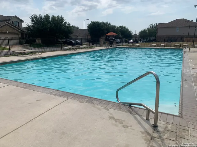 a view of a swimming pool with a yard