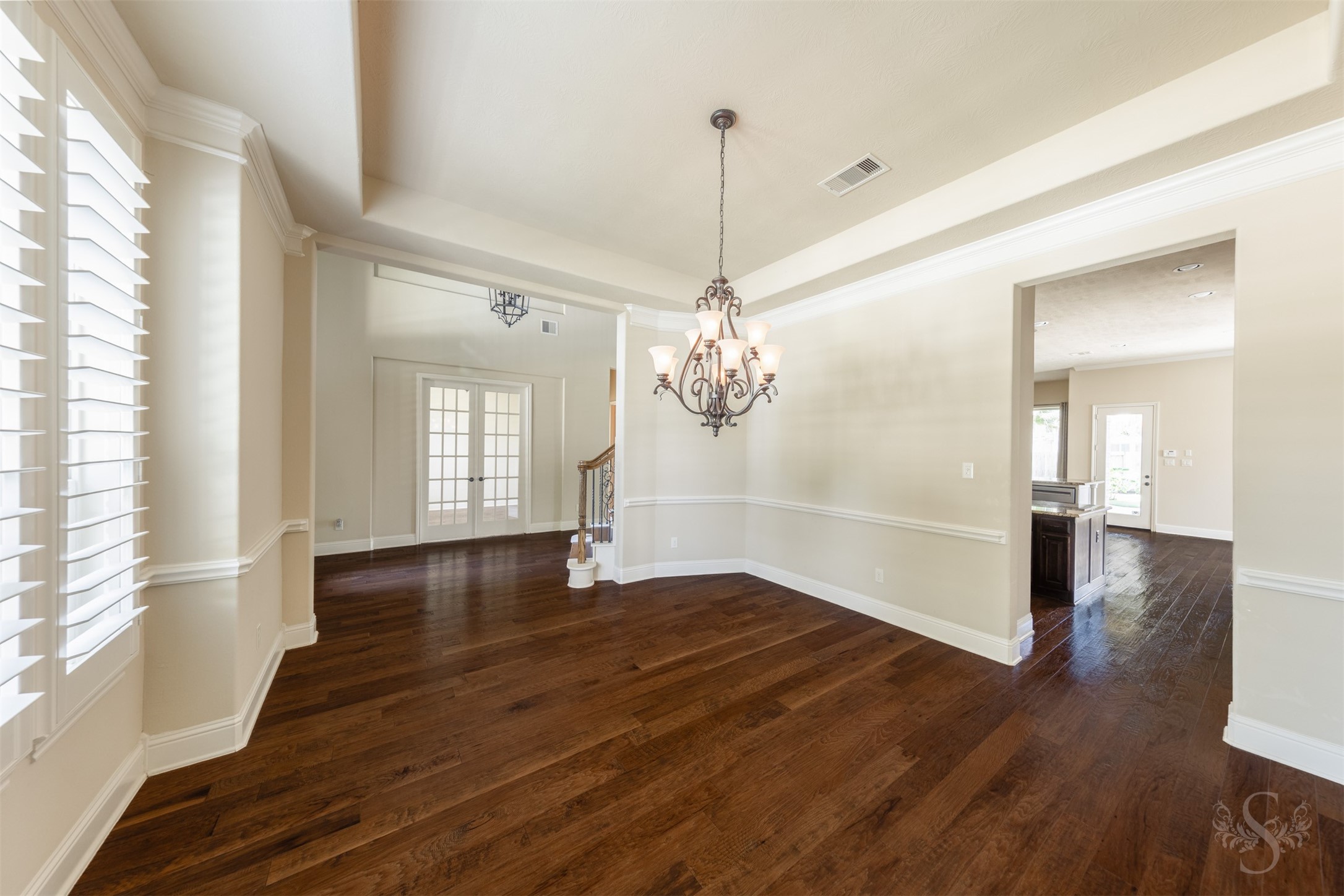 5803 Mustang Ridge Lane Fulshear, TX 77441 - Photo 9 of 48 Positioned just off the grand entry, the formal dining room creates a seamless flow into the main living areas. Wood flooring, detailed trim work and abundant natural light enhance the room’s timeless appeal.