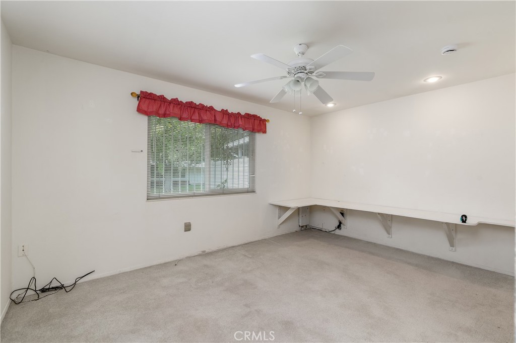 28121 Pebble Beach Drive Menifee, CA 92586 - Photo 15 of 35 an empty room with windows and fan