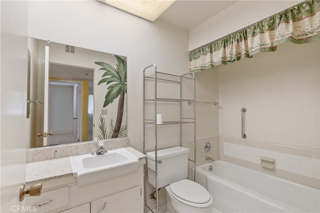 28121 Pebble Beach Drive Menifee, CA 92586 - Photo 16 of 35 a bathroom with a sink a toilet and shower