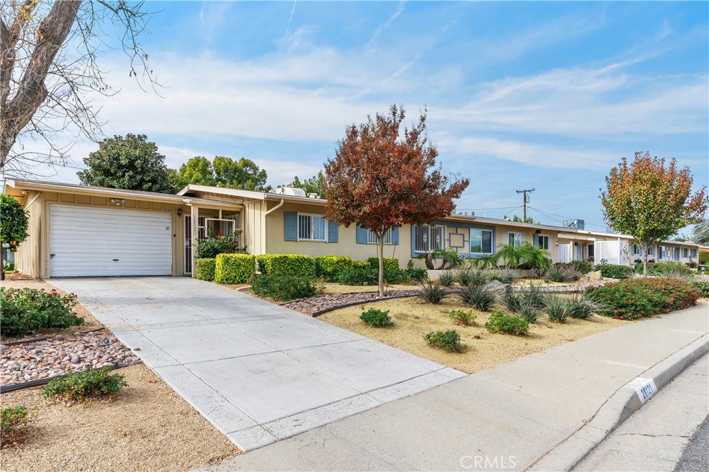 28121 Pebble Beach Drive Menifee, CA 92586 - Photo 2 of 35 a front view of a house with a yard and garage